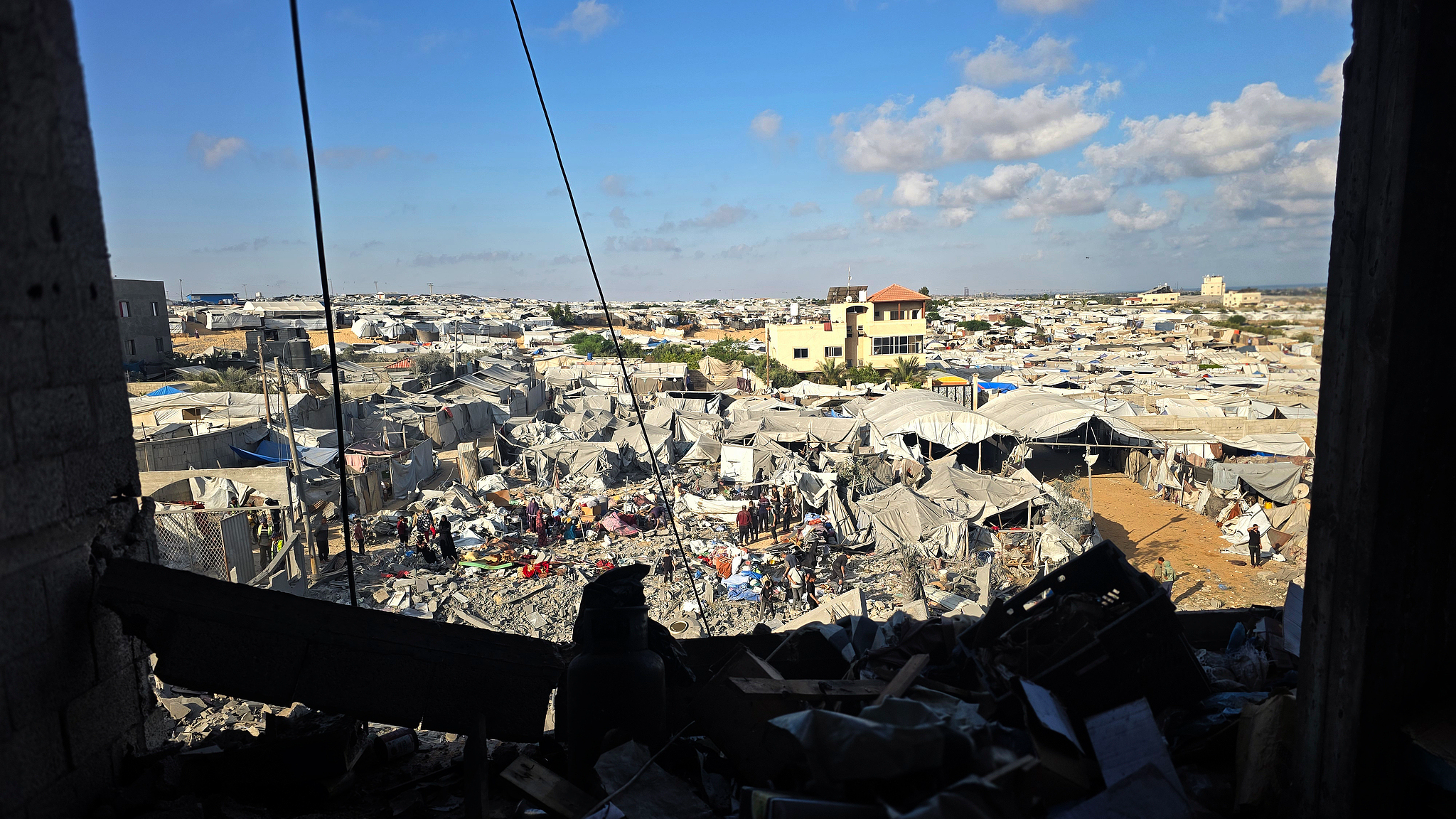 Palestinians inspect the destruction caused by an Israeli air strike that targeted tents and shelters for displaced people in the Mawasi area of Khan Younis, southern Gaza Strip, June 7, 2026. /VCG