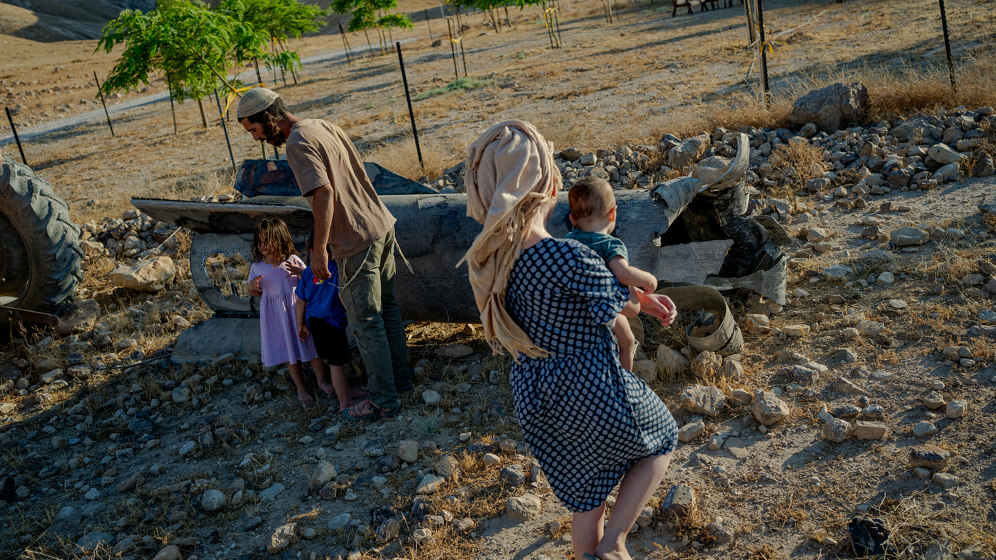 Israeli settlers use a tractor to haul away a large section of a downed Iranian missile toward their farm on the outskirts of Jericho, June 8, 2026. /VCG