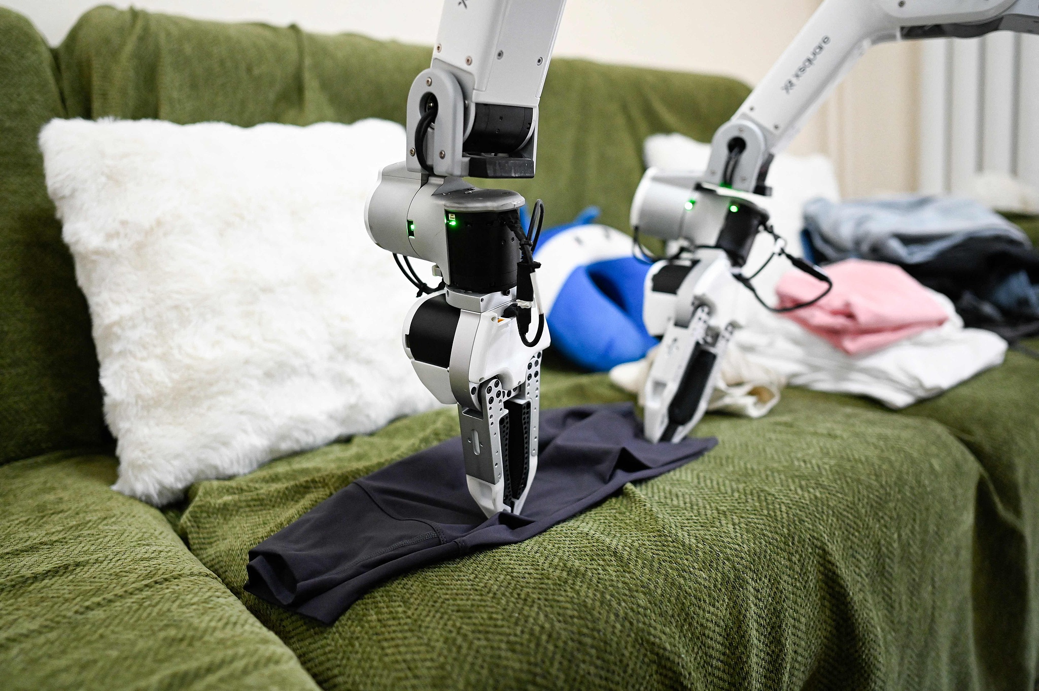 X Square Robot is folding clothes at a customer's home in Beijing, China, May 21, 2026. /VCG