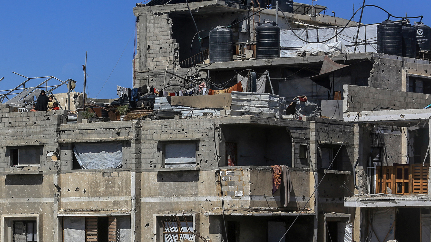 A view of destruction as Palestinians, deprived of basic necessities, carry on with their daily lives under difficult conditions in makeshift tents set up near their destroyed homes and in heavily damaged buildings in Khan Yunis, Gaza, Palestine, June 9, 2026. /VCG