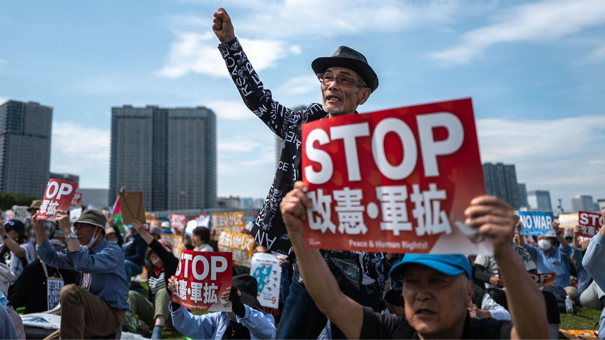 People hold placards reading 