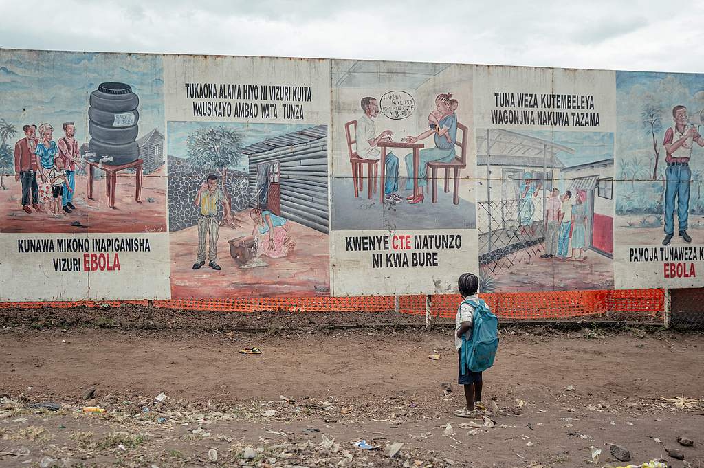 A child returning from school stops to look at Ebola awareness illustrations displayed on the signboards of the Ebola Treatment Center, Munigi, Democratic Republic of the Congo, June 2, 2026. /VCG