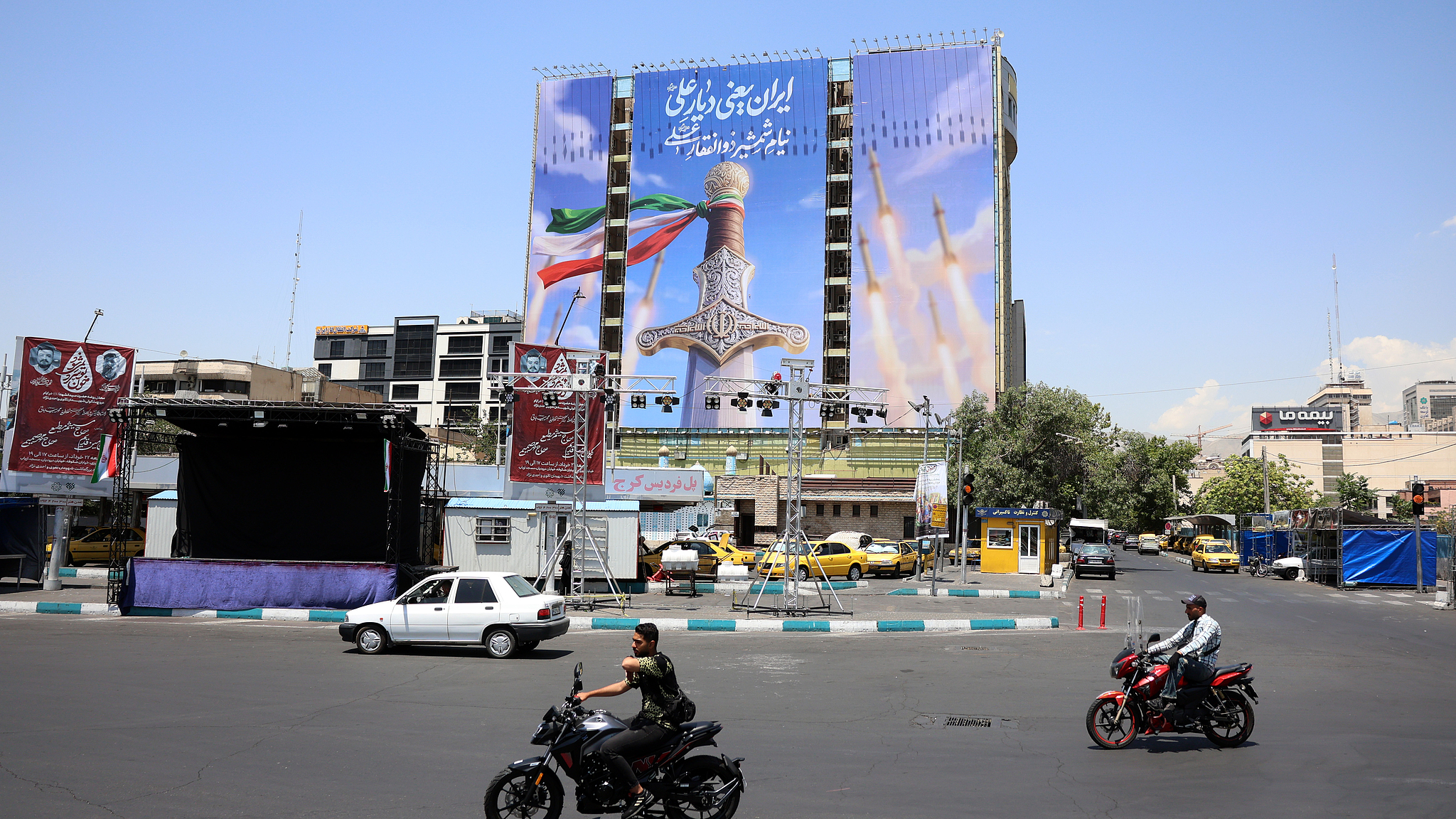 A large-scale political billboard featuring Iranian missiles and a sword at Vanak square in Tehran, Iran, 11 June 2026. /VCG