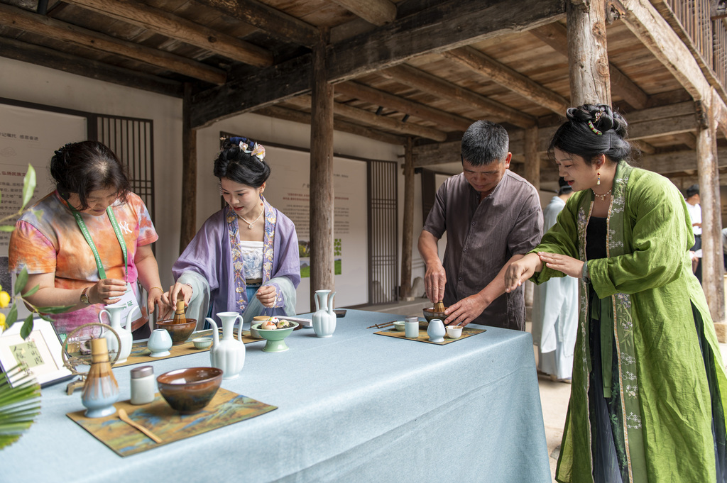 A special folk art show featuring items of national intangible cultural heritage is held at the Yushan Ancient Tea Plantation in Pan'an County, Jinhua City, Zhejiang Province, on 13 June 2026. /VCG