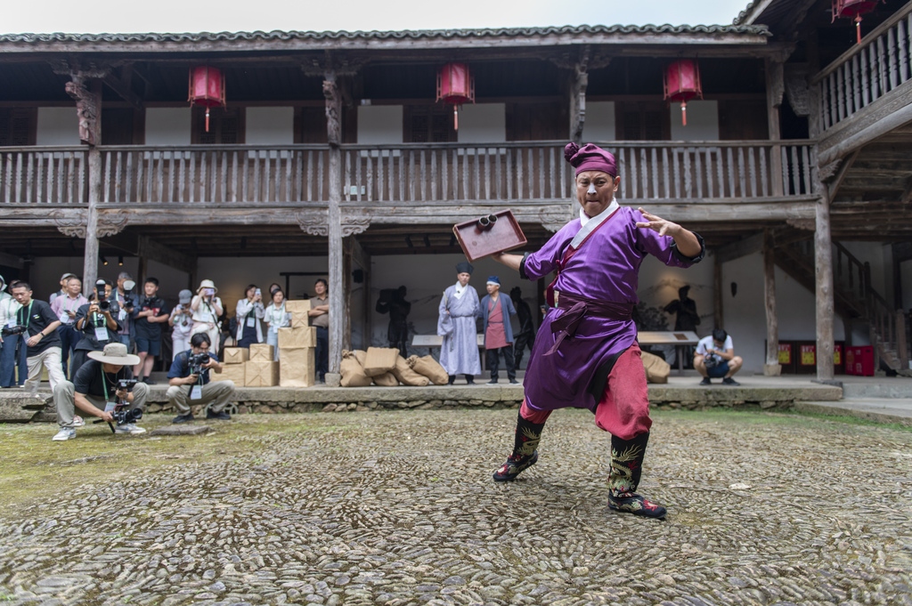 A special folk art show featuring items of national intangible cultural heritage is held at the Yushan Ancient Tea Plantation in Pan'an County, Jinhua City, Zhejiang Province, on 13 June 2026. /VCG