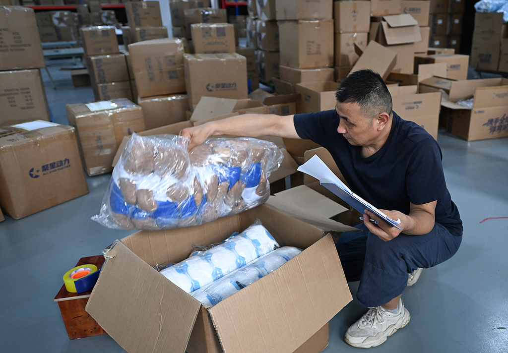 Workers pack FIFA World Cup merchandise to be shipped domestically and overseas in Yiwu, Zhejiang Province, China, June 4, 2026. /VCG