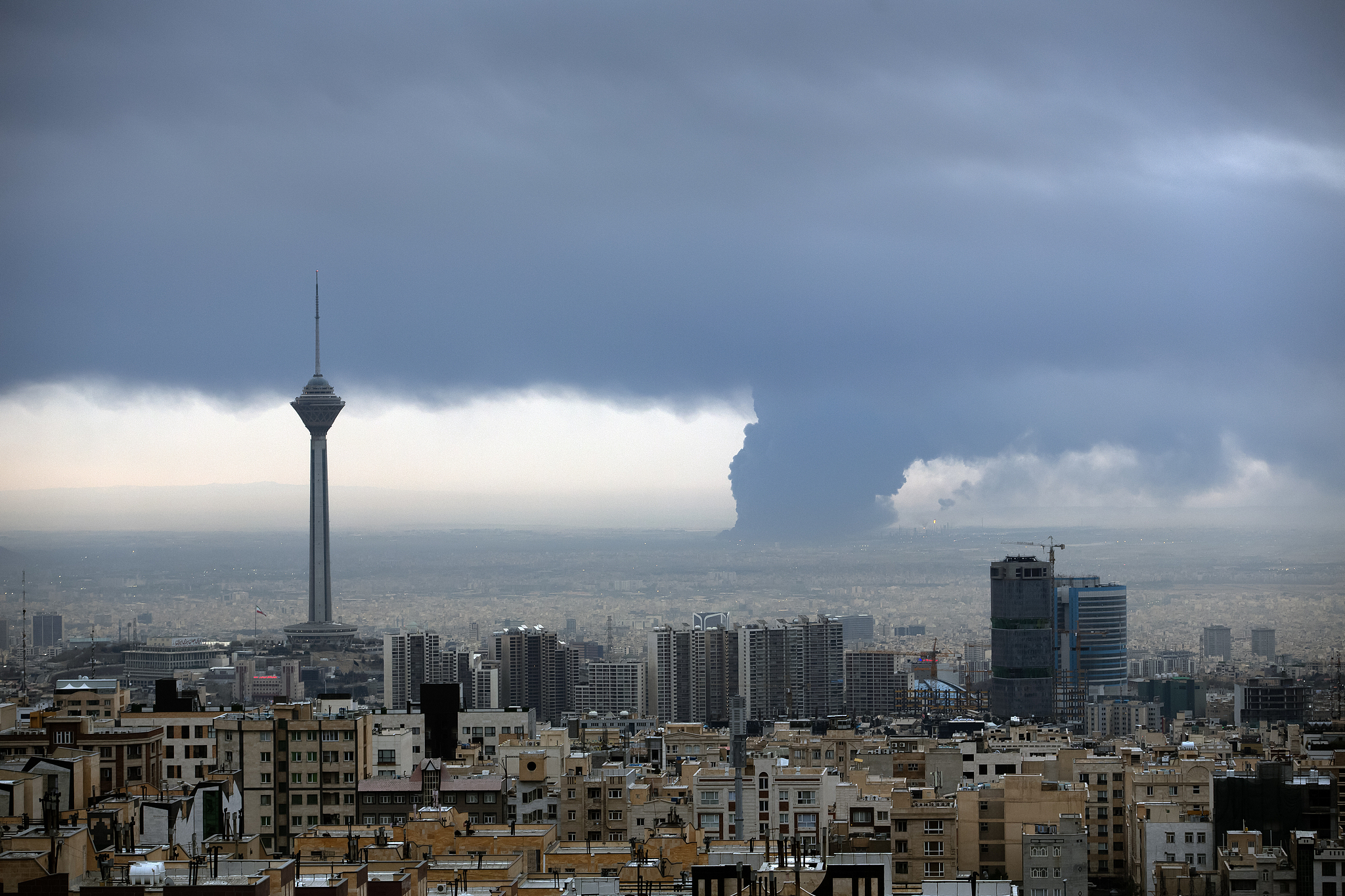 Smoke rises from Shahran oil depot after US and Israeli attacks, leaving numerous fuel tankers and vehicles in the area unusable in Tehran, Iran on March 8, 2026. /VCG