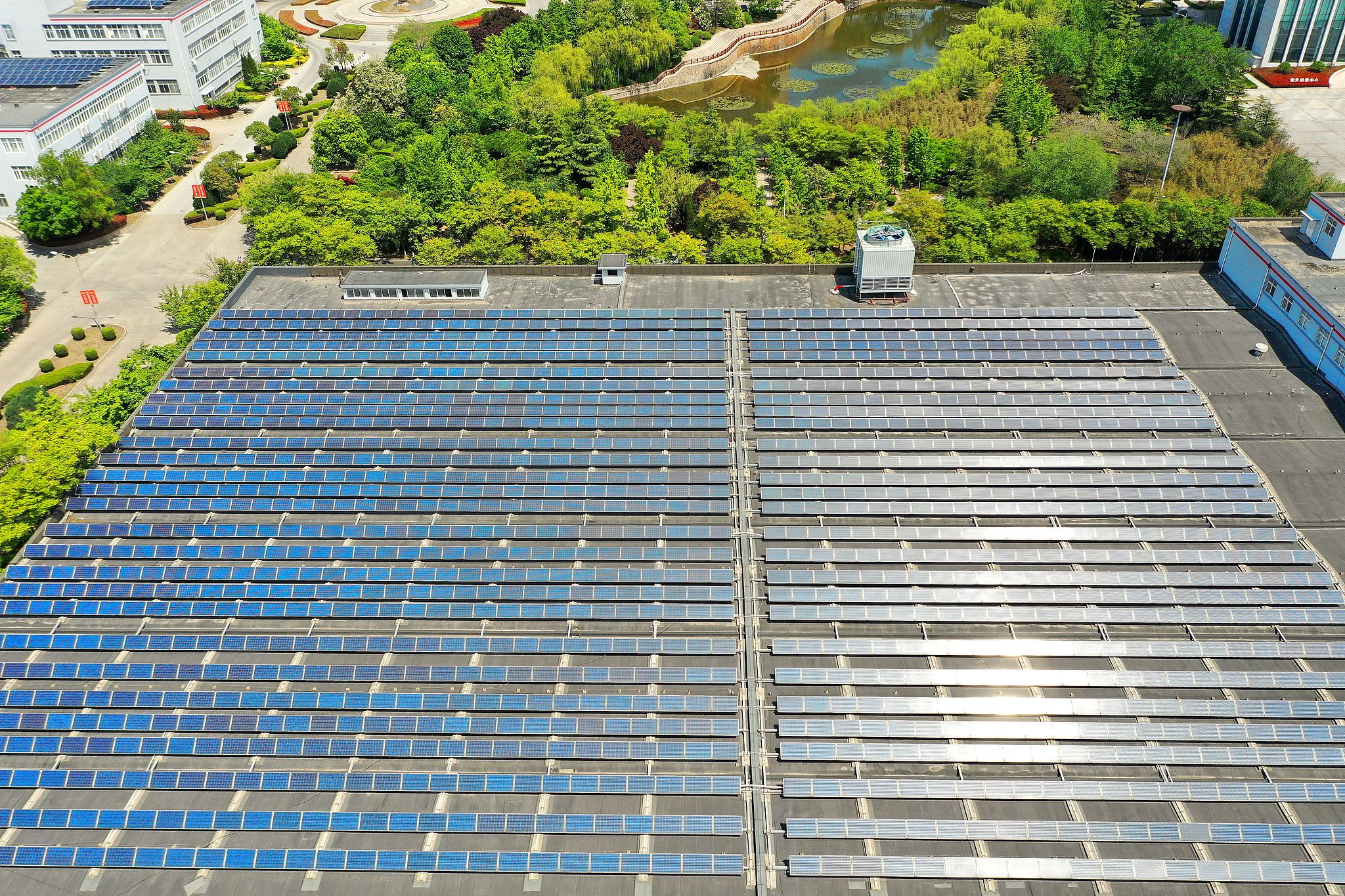 Photovoltaic panels neatly arranged on factory rooftops, Qingdao, Shandong Province, China, April 29, 2026. /VCG