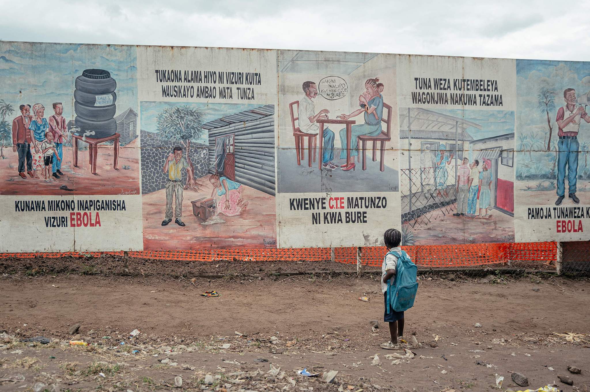 A child returning from school stops to look at Ebola awareness illustrations displayed on the signboards at the Ebola Treatment Center in Munigi, Democratic Republic of the Congo, June 2, 2026. /VCG