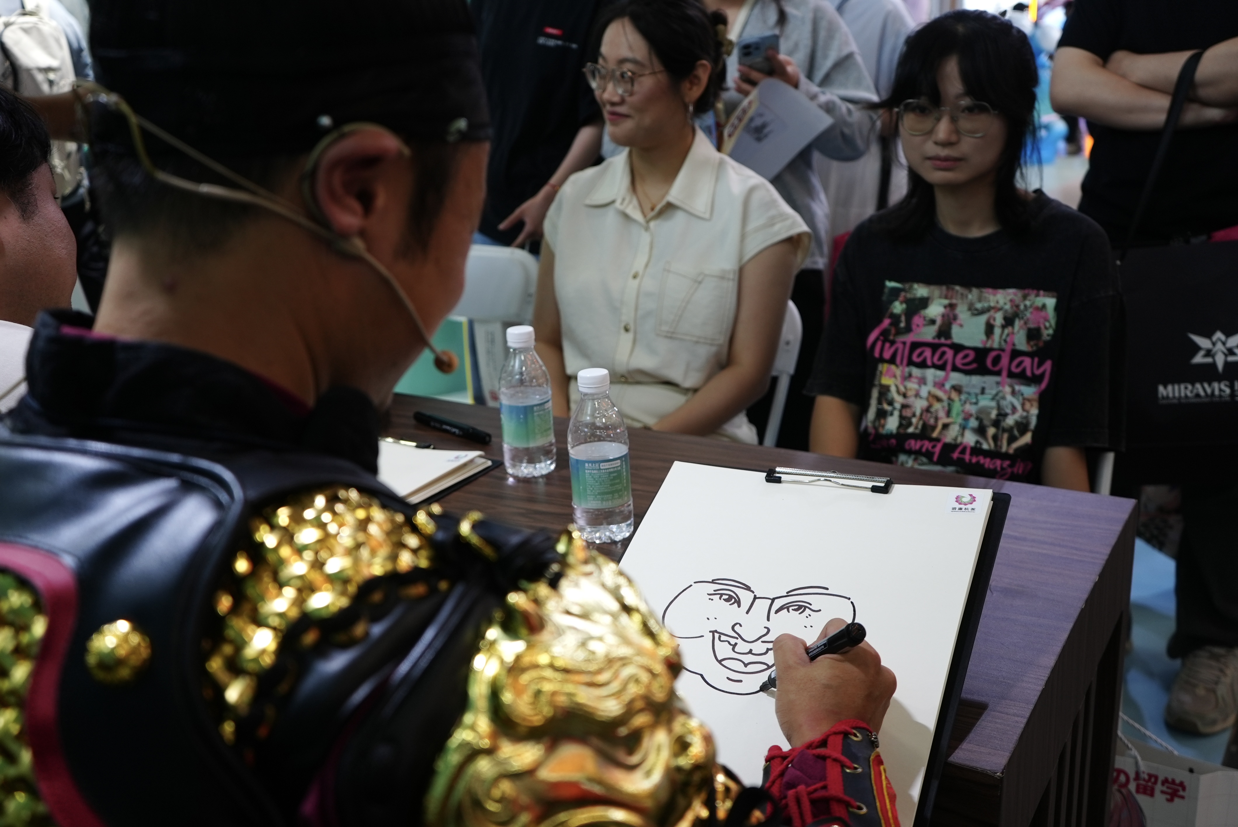 A comic artist draws cartoon figures for visitors at CICAF, Hangzhou, June 17, 2026. Chen Hongyu/CGTN