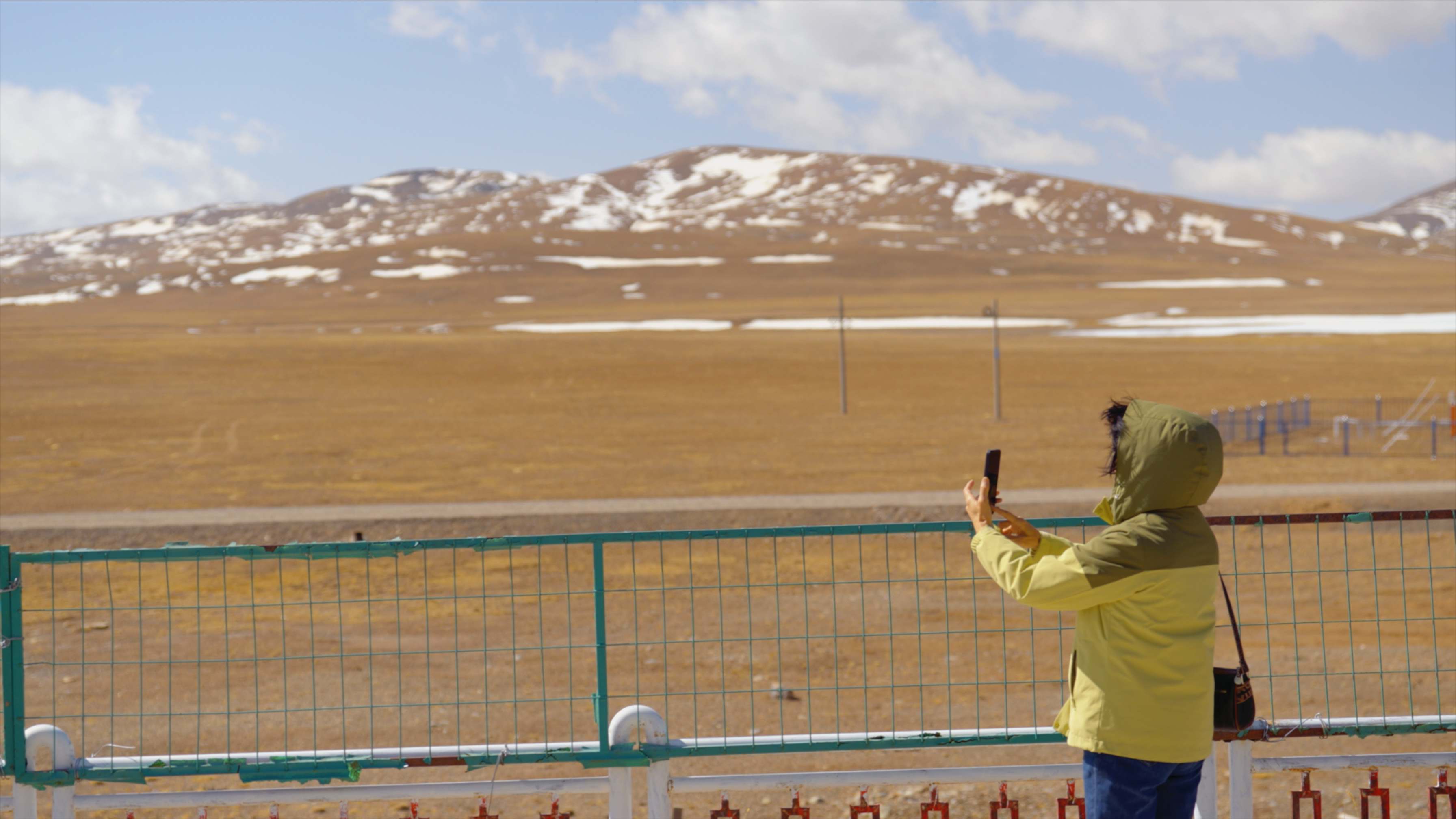A tourist takes pictures at Tanggula Railway Station in Haixi Mongolian and Tibetan Autonomous Prefecture, Qinghai Province, May 23, 2026. Zhang Chao/CGTN