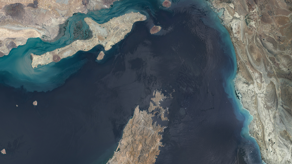 A broad overview of the Strait of Hormuz, including the Musandam Peninsula, nearby islands, coastal shallows, and the narrow maritime corridor linking the Persian Gulf with the Gulf of Oman. /VCG