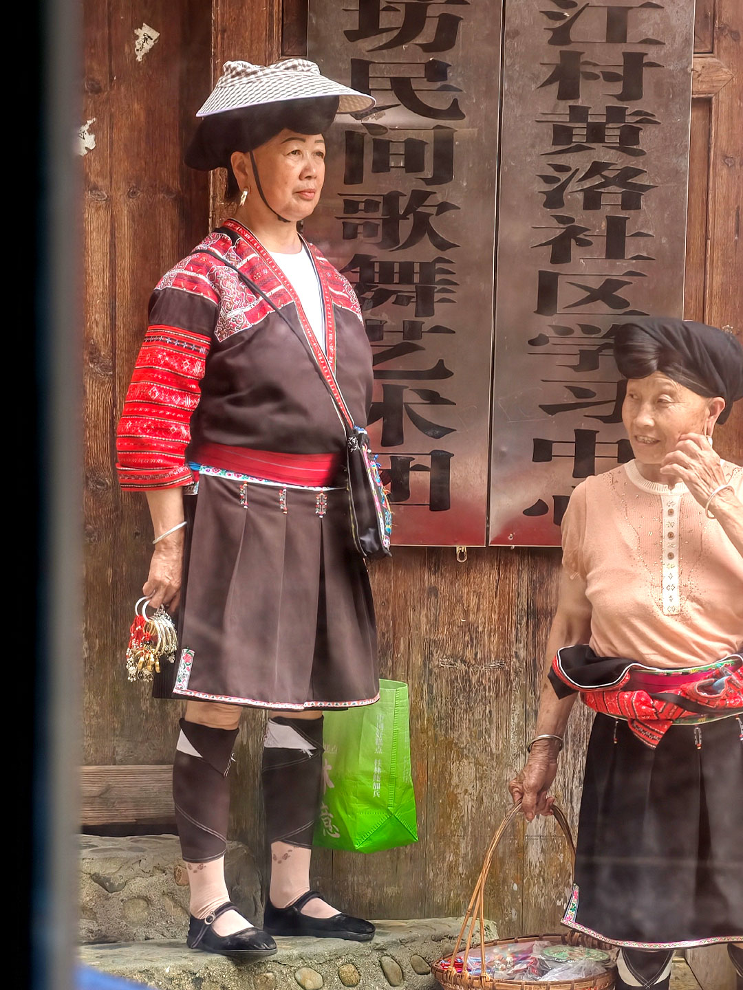 Traditional dress remains part of everyday life in the village. /CGTN