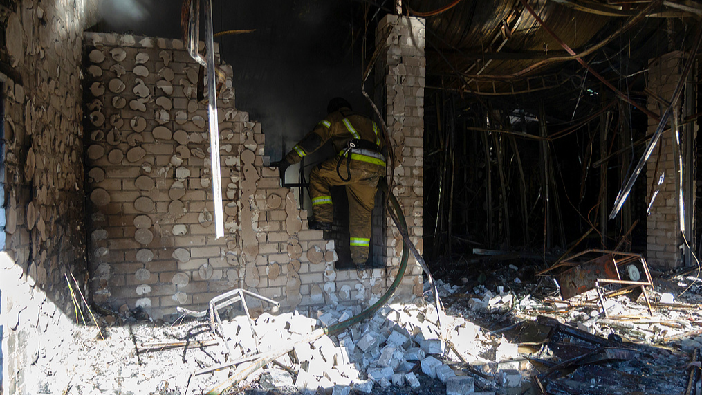 A rescuer works during the cleanup operation following a Russian military operation on a market area near the Shuliavska metro station in Kyiv, Ukraine, June 15, 2026. /VCG