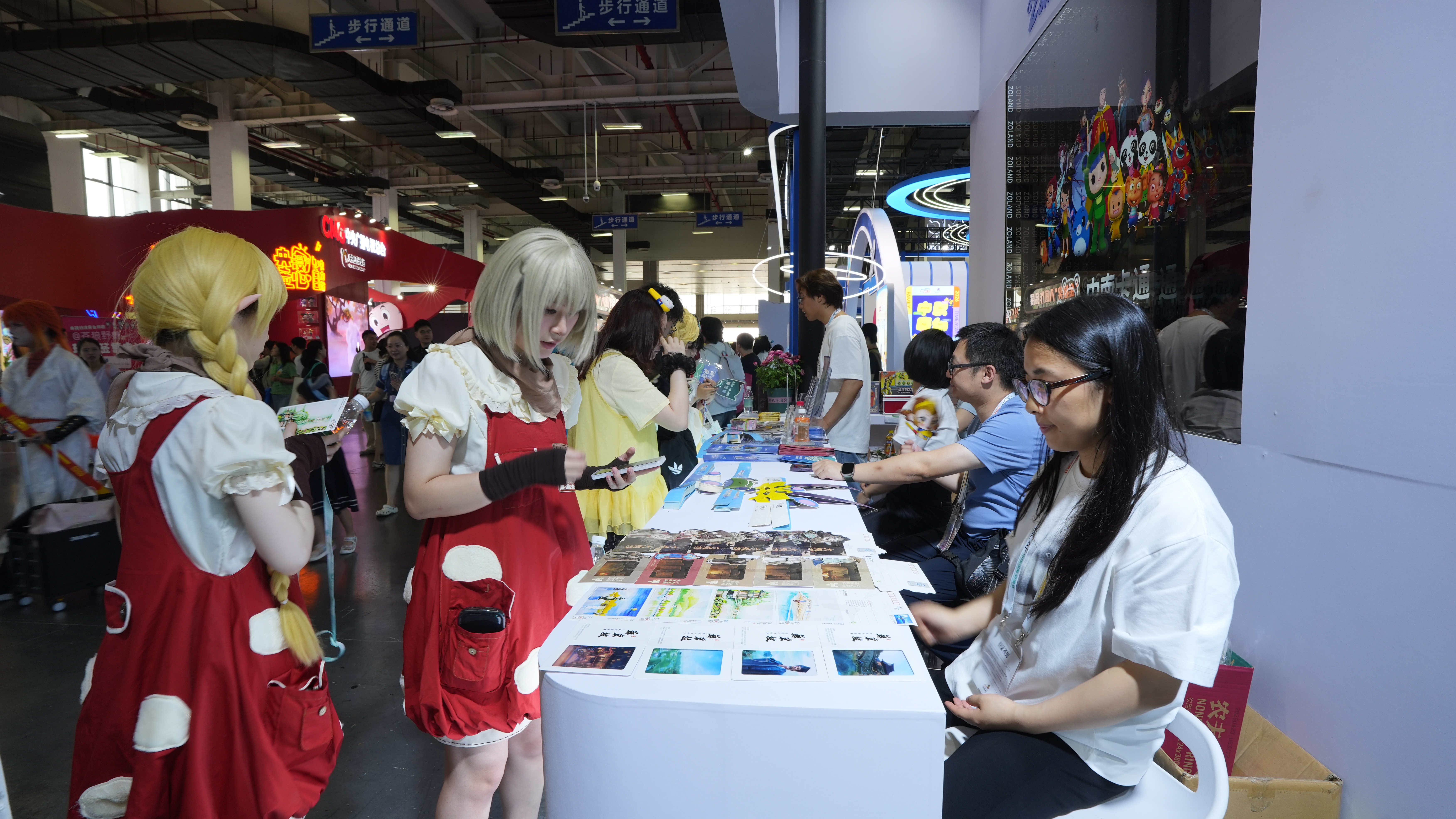Cosplayers interact with the staff at the booth at the 22nd CICAF, Hangzhou City, June 19, 2026. /CGTN