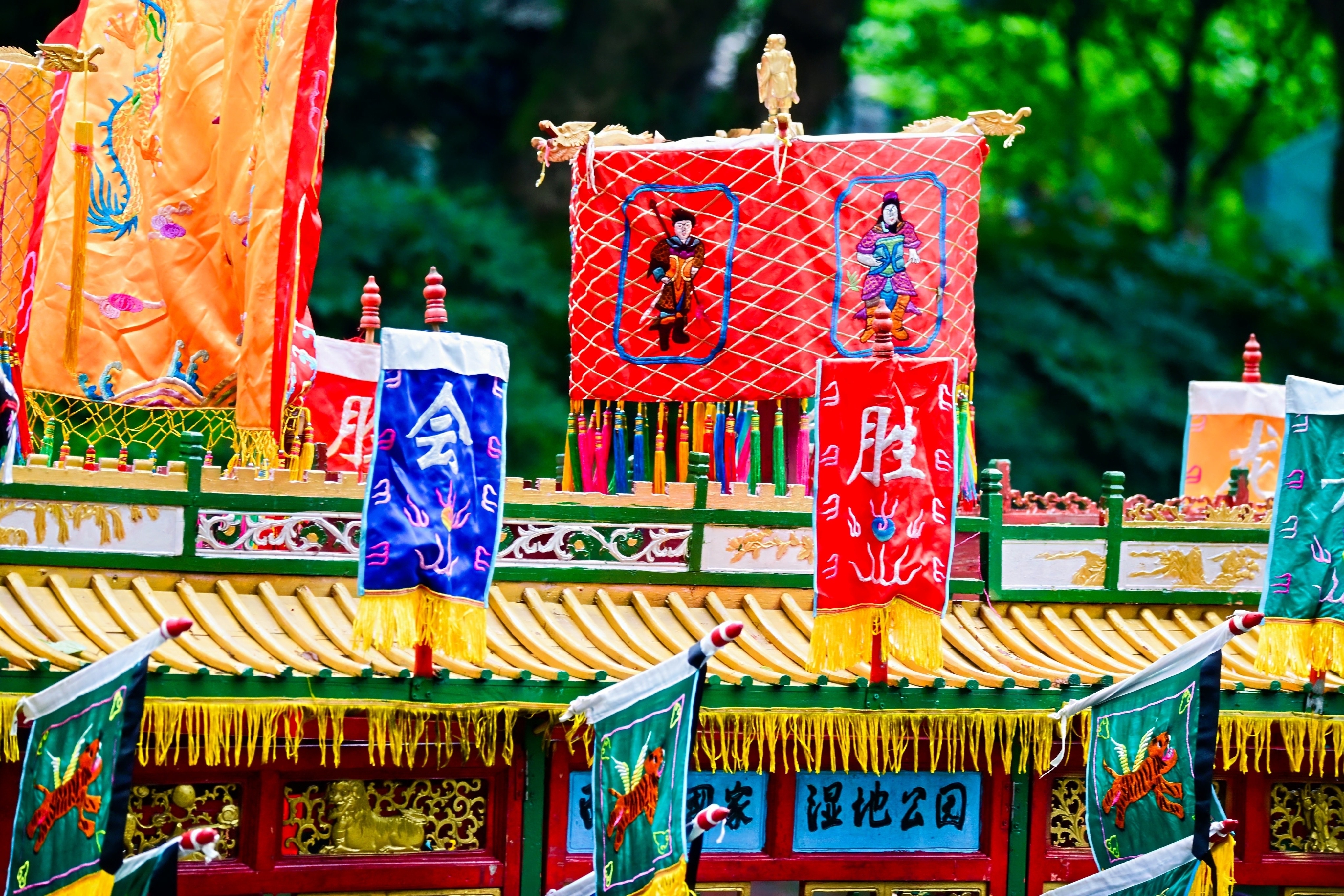 Colorful dragon boats, adorned with bright flags and banners, await the race in Hangzhou, east China's Zhejiang Province, June 19, 2026. /Courtesy of CICAF