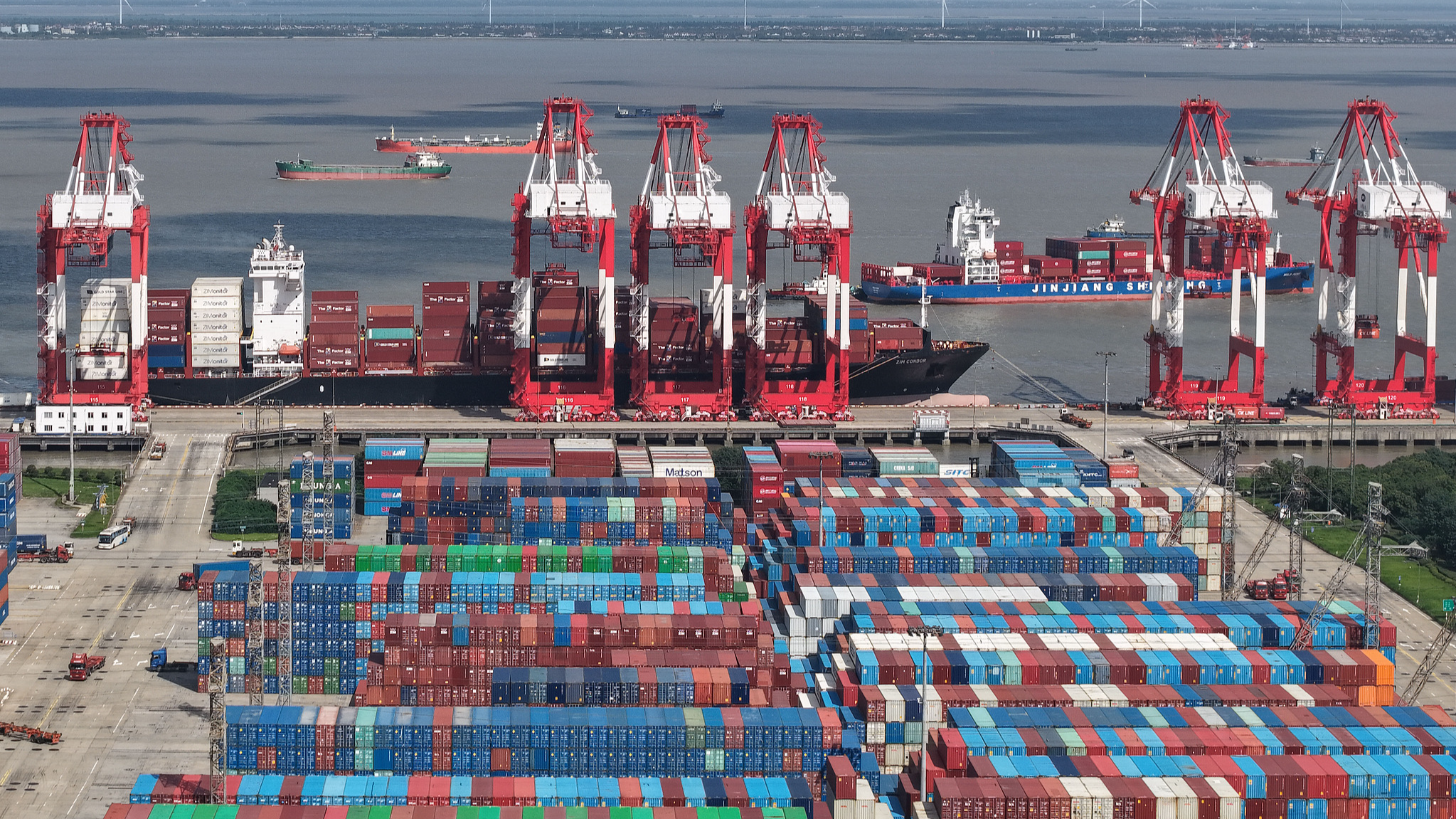 Heavy truck and vessel traffic is seen at the bustling container terminal of Shanghai Port's foreign trade area in east China, June 9, 2026. /VCG