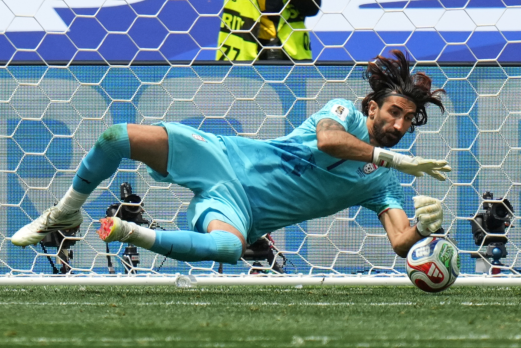 Iran goalkeeper Alireza Beiranvand saves a shot against Belgium in a Group G match at the 2026 FIFA World Cup in Inglewood, California, June 21, 2026. /VCG