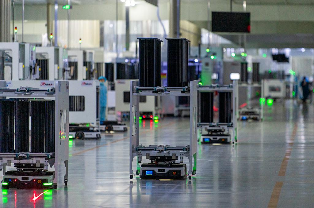 Automated guided vehicles operate in an intelligent production workshop in a local tech enterprise in Jinhua City, east China's Zhejiang Province. /VCG