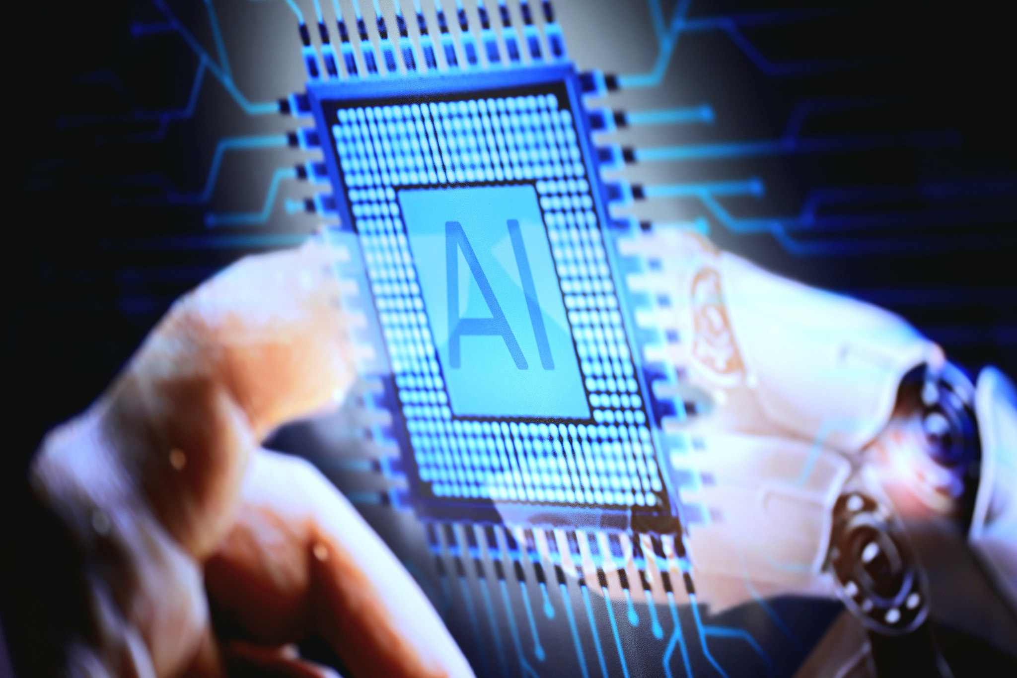 A humanoid robot hand and an AI chip. /VCG