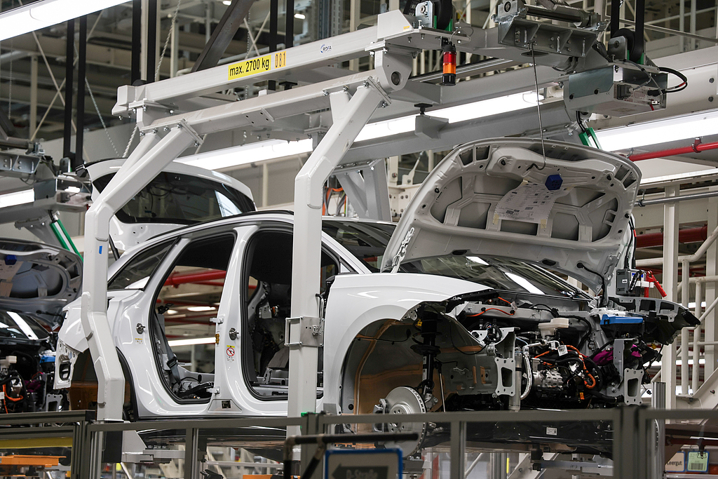A Volkswagen ID line electric car is hanging in a holding device on the assembly line, Emden, Germany, February 24, 2026. /VCG