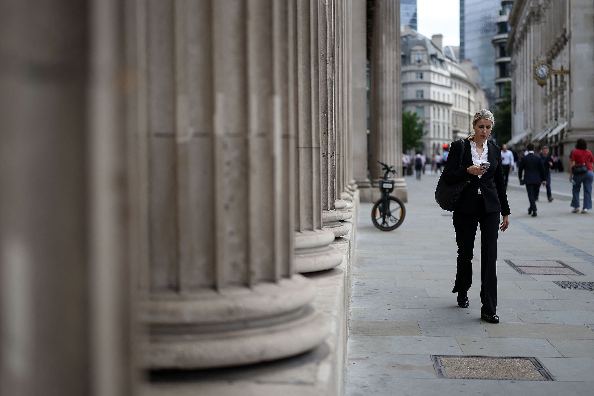 Pedestrians walking past the Bank of England in the City of London, UK, on June 18, 2026. /AFP