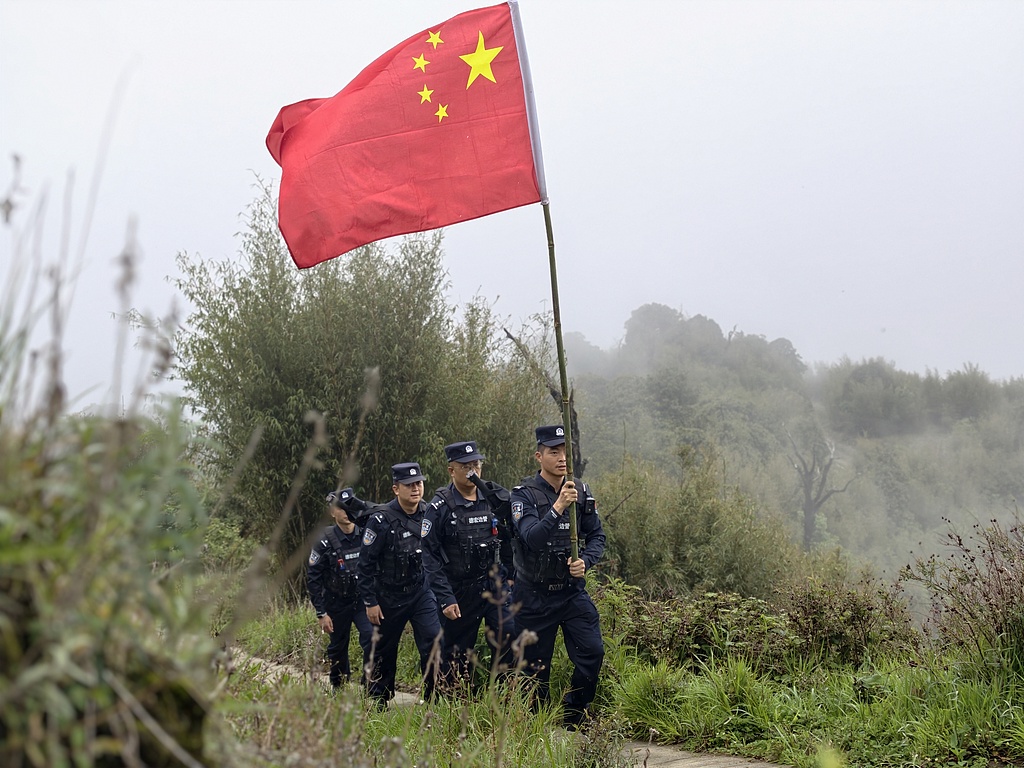 Police officers of the Yingjiang Border Management Brigade patrol near China-Myanmar boundary marker No. 5 on June 24, 2026. /VCG