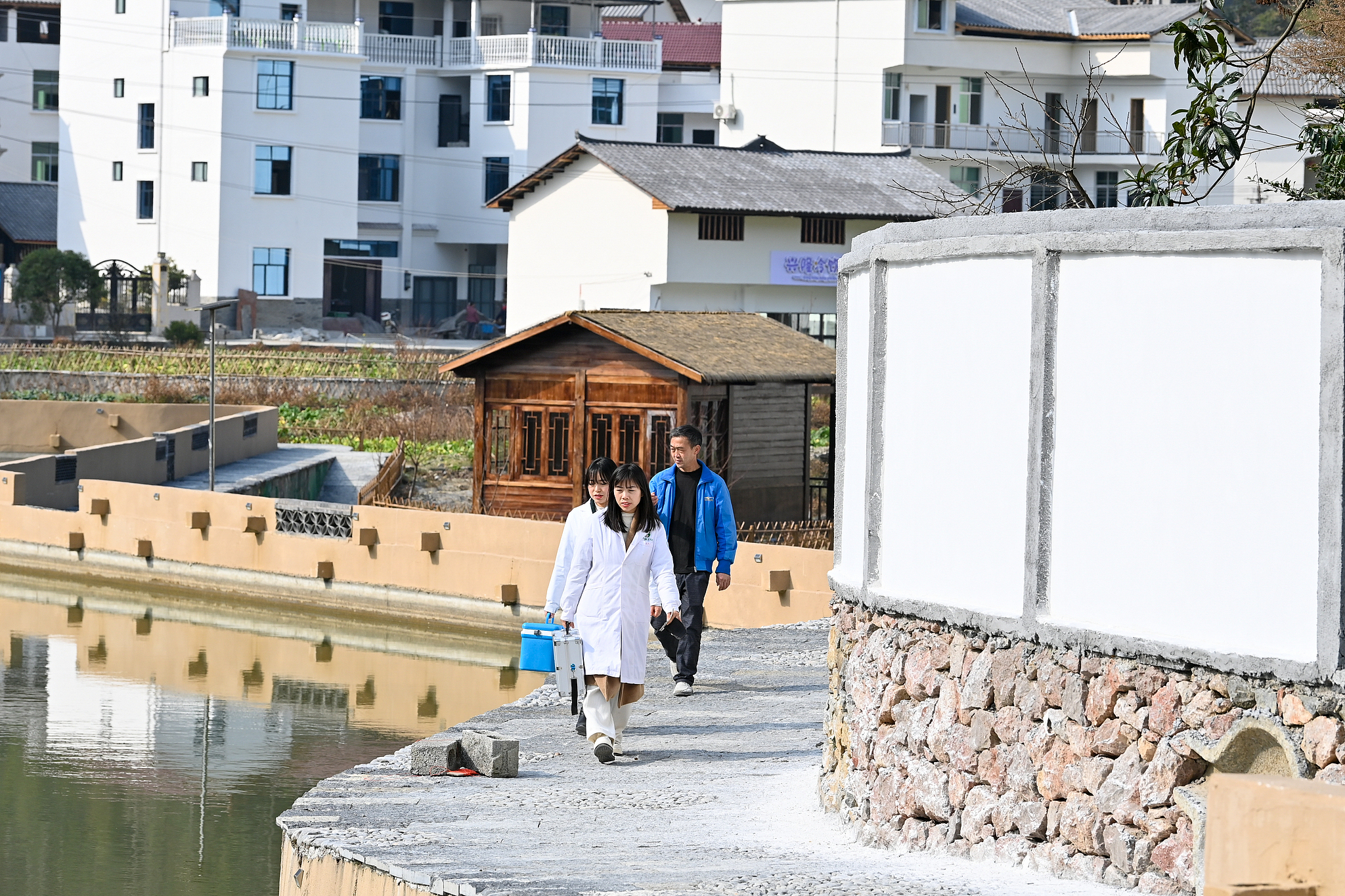Contracted family doctors conduct a home visit to check on a villager's health condition in Youyang Tujia and Miao Autonomous County, southwest China's Chongqing Municipality, January 11, 2024. /CFP