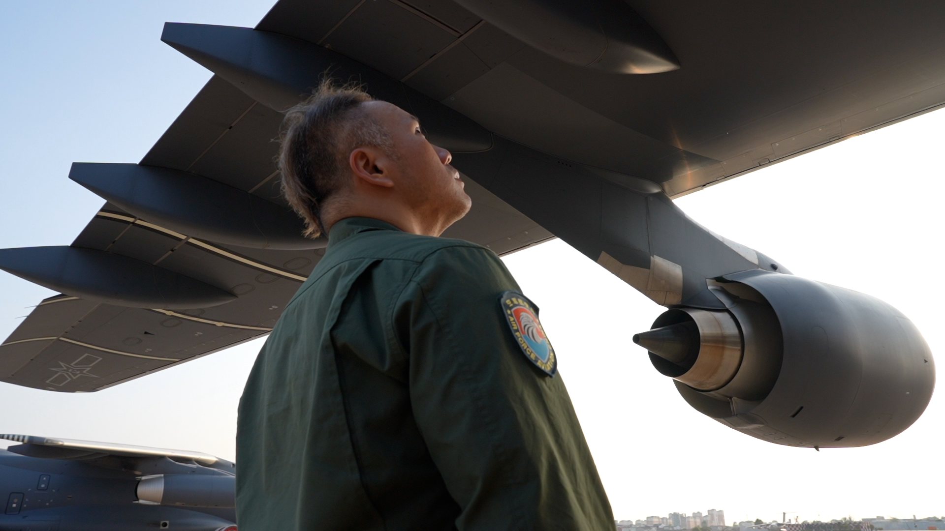 Zhang Peng, Y-20 captain and flight instructor, stands under the wing of the aircraft. /PLA Air Force