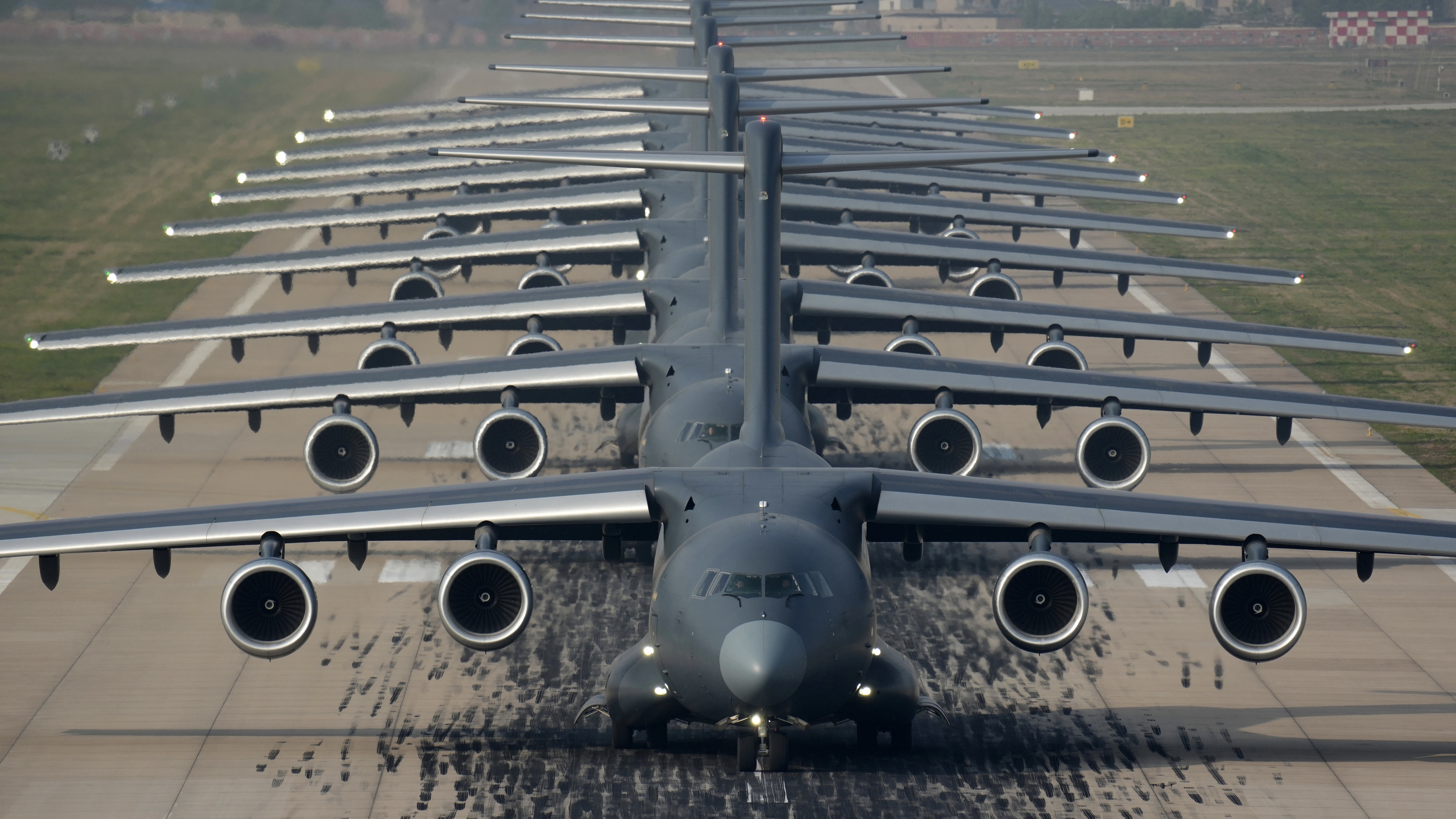 A formation of Y-20 transport aircraft taxiing down the runway. /PLA Air Force