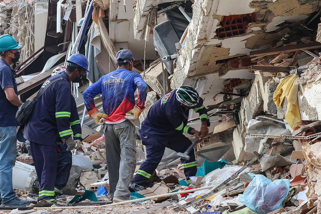 People and rescuers search for victims amid the debris of a demolished building at Caraballeda after strong earthquakes struck Venezuela and other parts of the Caribbean, in La Guaira, Venezuela, June 27, 2026. /VCG