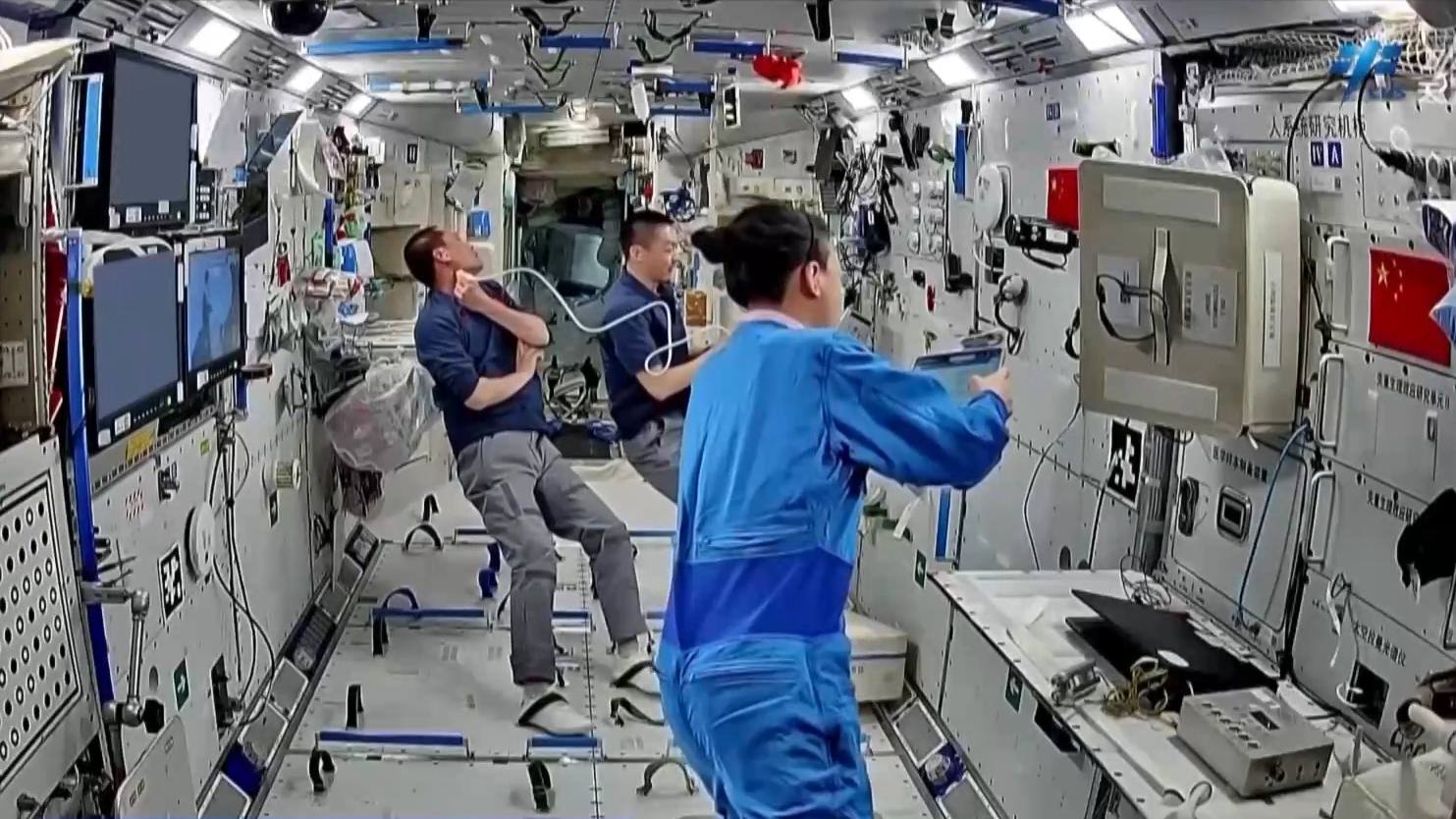 China's Shenzhou-23 crew using an ultrasound diagnostic device to perform examinations on neck. /CMG