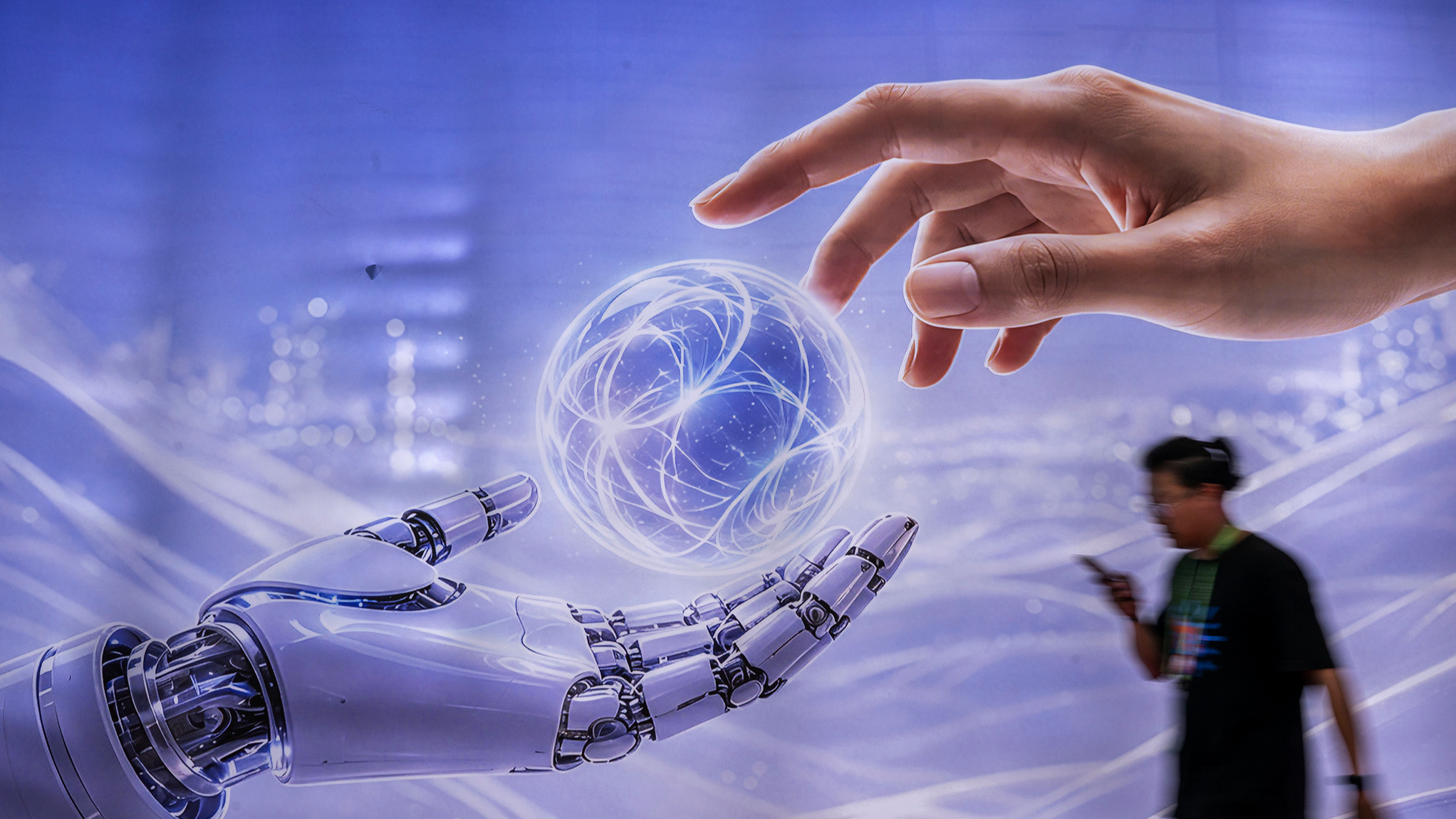 A man walks past a billboard featuring humanoid robots at the AI exhibition area of the 4th China International Supply Chain Expo (CISCE) in Beijing, China, June 26, 2026. /VCG