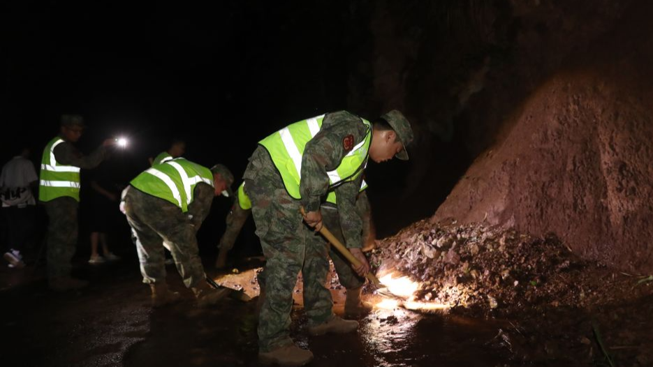 Rescue personnel clear rocks that fell onto a road following an earthquake in Gaoxian County, Yibin City, southwest China's Sichuan Province, June 29, 2026. /Xinhua