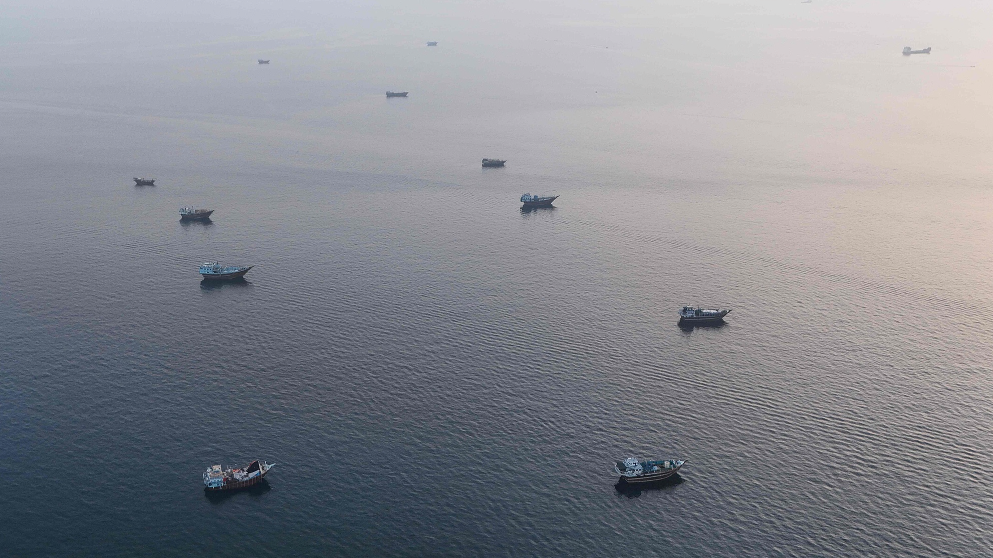 Boats are seen anchored off Oman's northern Musandam Peninsula near the Strait of Hormuz, June 27, 2026. /VCG