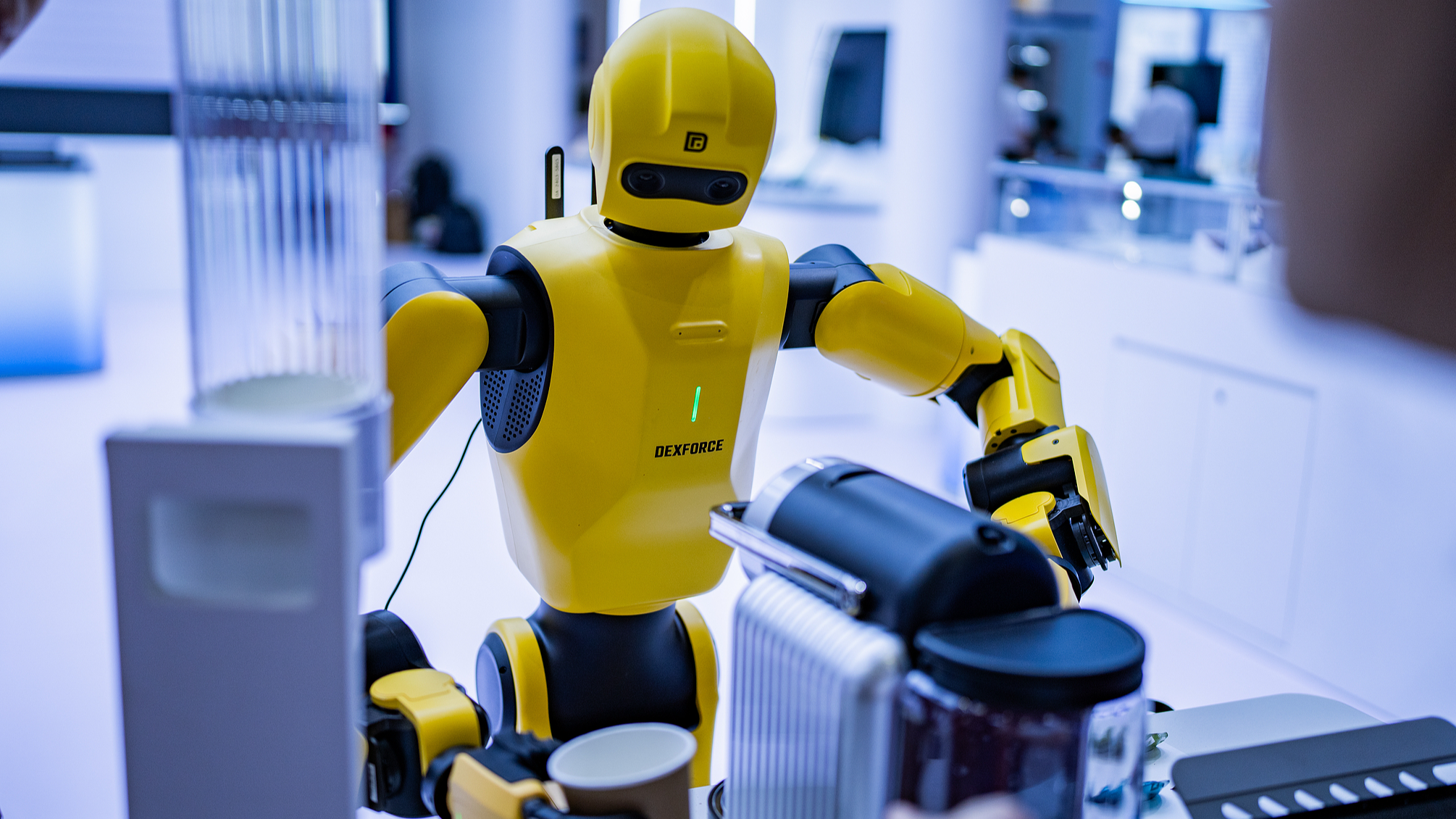 A humanoid robot making coffee at an expo in Beijing, China, June 23, 2026. /VCG