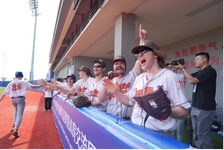 Brad Schurtz (R2), coach of the Near West Baseball Club of Virginia, cheers on his team during a baseball exhibition game against the Hong Kong Tigers Baseball Team at Pingtan Baseball Park in Fuzhou on June 30, 2026. /CGTN