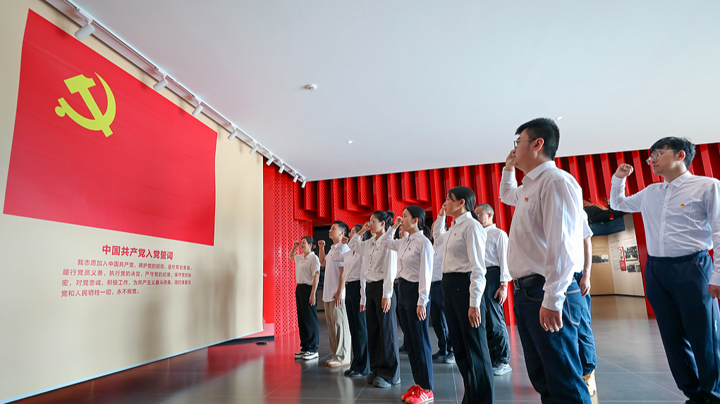 Party members renew their oath of admission before the Communist Party of China flag, in Qujing City, southwest China's Yunnan Province, June 26, 2026. /VCG