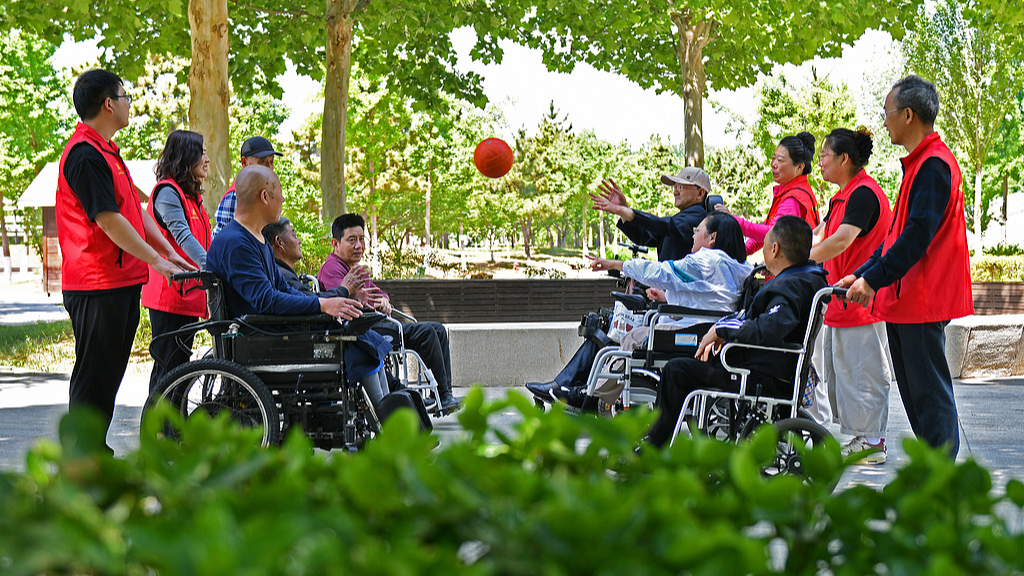 Volunteer assistants accompany people with disabilities in a fun ball game, Yantai, east China's Shandong Province, May 16, 2026. /VCG