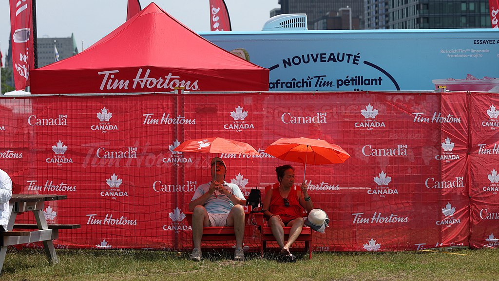 Revelers shelter under umbrellas on the grounds of LeBreton Flats during a heat wave on Canada Day in Ottawa, Ontario, Canada, July 1, 2026. /VCG