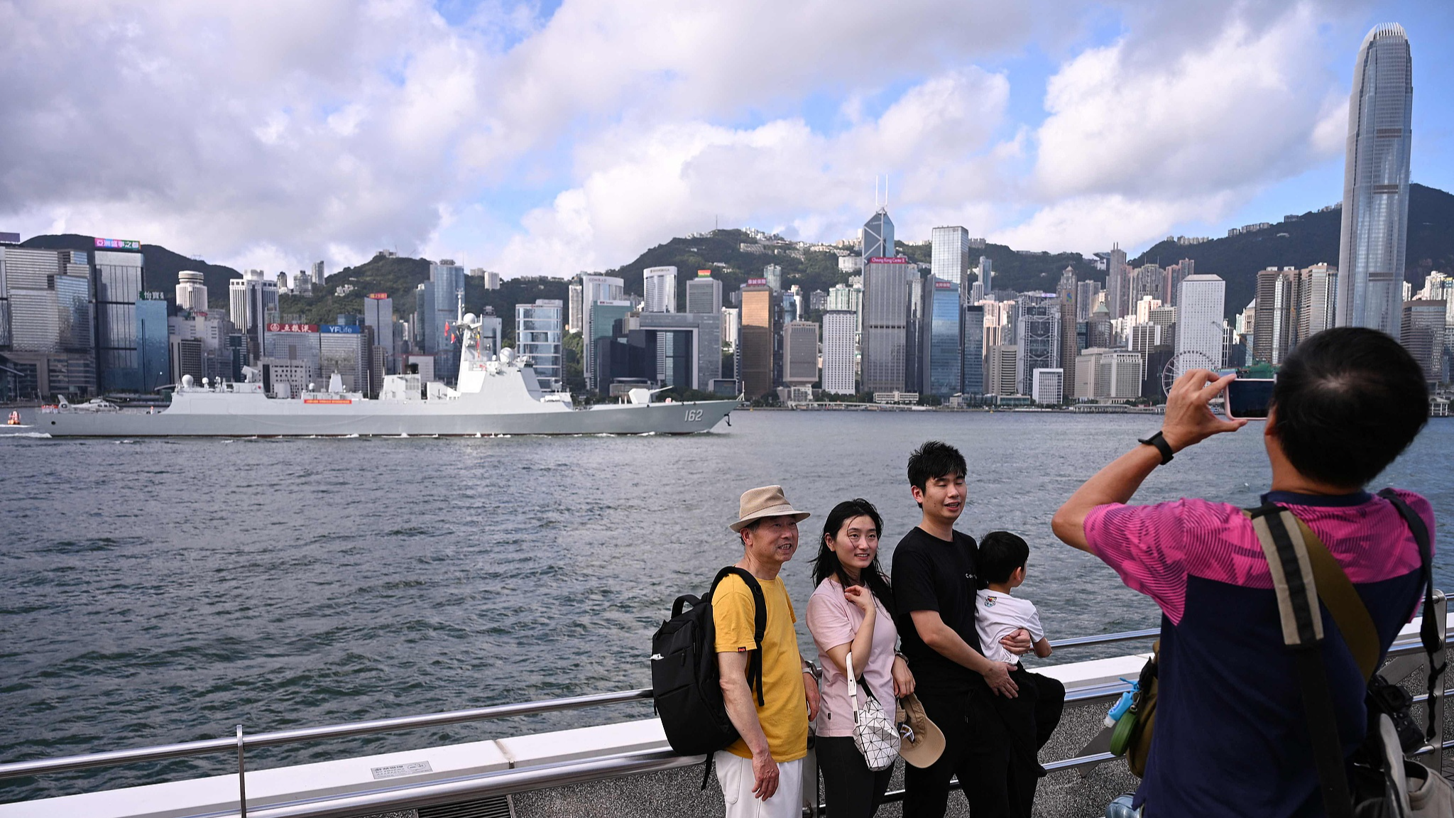 People take photos in front of the guided-missile destroyer Nanning at Victoria Harbour in Hong Kong Special Administrative Region, China, July 2, 2026. /VCG
