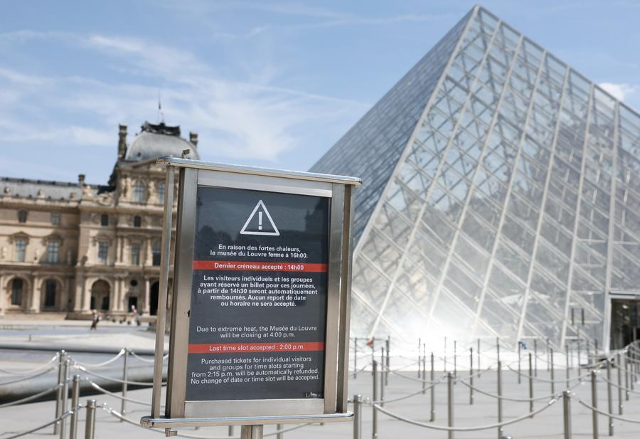 A signboard in front of the Louvre Museum shows that the museum would close early at 4 p.m. due to the heatwave, in Paris, France, June 25, 2026. /Xinhua