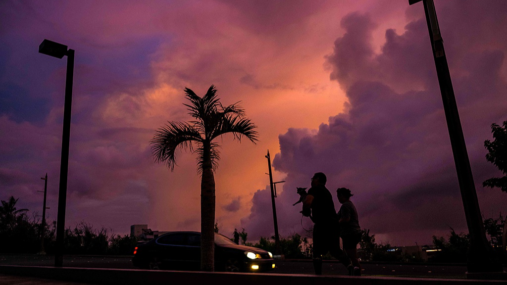 People walk along a street at sunset ahead of the arrival of the forecasted Super Typhoon Bavi in the Mariana Islands, US, July 4, 2026. /VCG