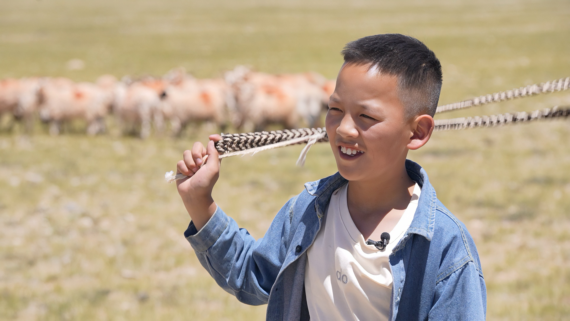 Tenzin Lobsang herds sheep on the grasslands near his grandparents' home during the last days of summer vacation in Baingoin County, Nagqu, Xizang Autonomous Region, August 15, 2025. /CGTN