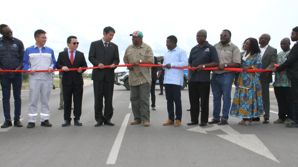 John Mutorwa (5th L), Namibia's deputy prime minister and minister of works and transport, and representatives from China and Namibia cut the ribbon at the official opening of the Chinese-constructed John Mutorwa Road in Rundu, Namibia, March 14, 2025. /Xinhua