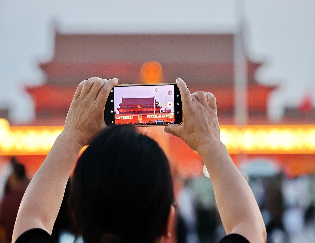People watch the national flag-raising ceremony celebrating the 105th anniversary of the founding of the Communist Party of China in Beijing, China, July 1, 2026. /CFP