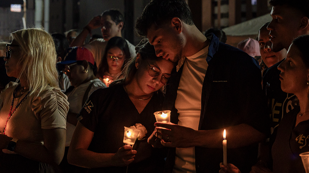 A group of people take part in a vigil held in honor of the victims of the recent earthquakes in Caracas, Venezuela, July 5, 2026. /VCG