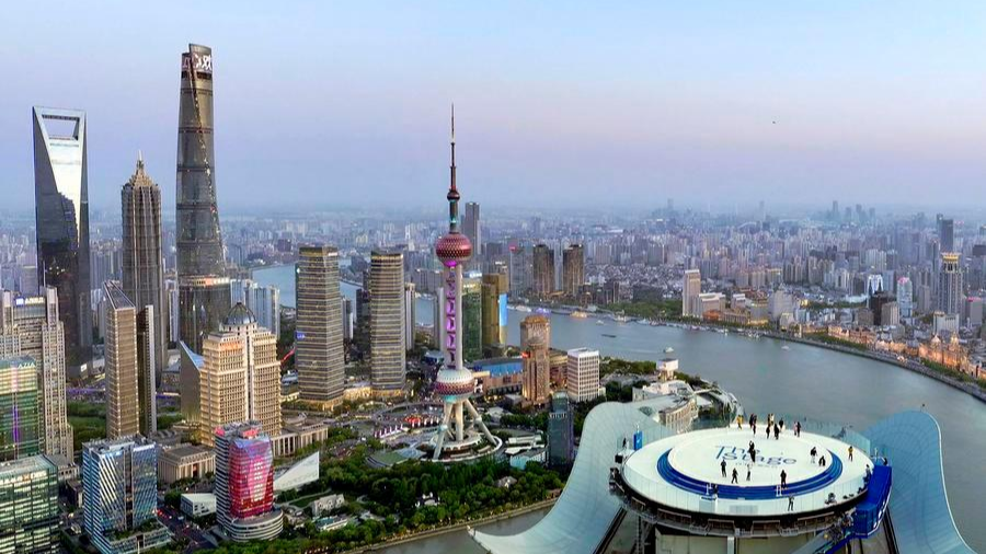 An aerial drone photo shows visitors enjoying the cityscape at The Stage, a new observation deck atop White Magnolia Plaza in Shanghai, east China, April 14, 2025. /Xinhua