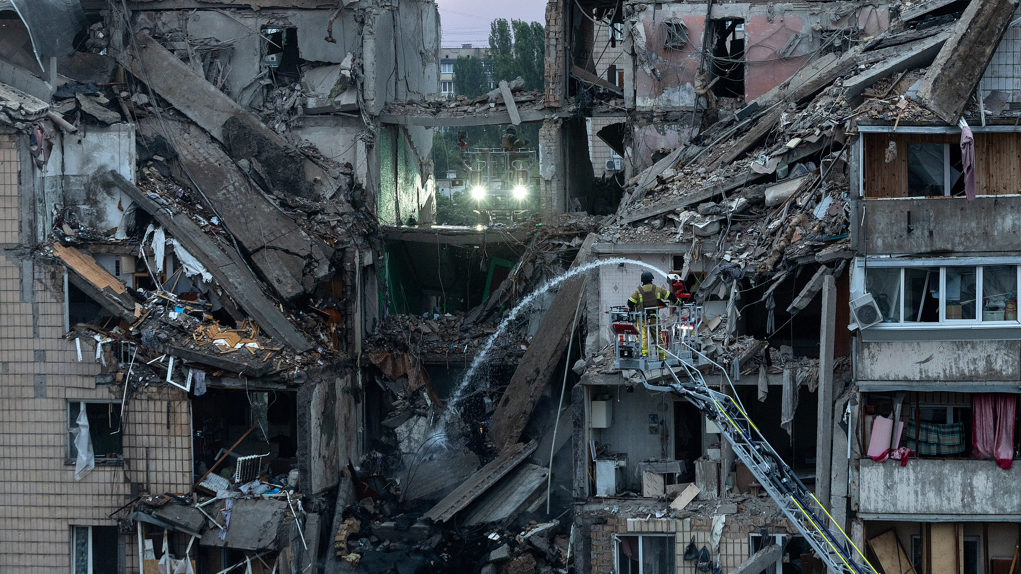 Firefighters work at a partially collapsed building following an overnight Russian missile and drone attack, Kyiv, Ukraine, July 6, 2026. /VCG