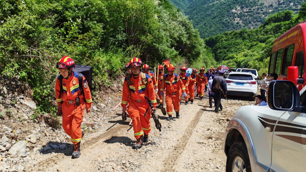 Rescue team members walk toward a landslide scene in Tanchang County, Longnan City, Gansu Province, China on July 7, 2026. /Xinhua